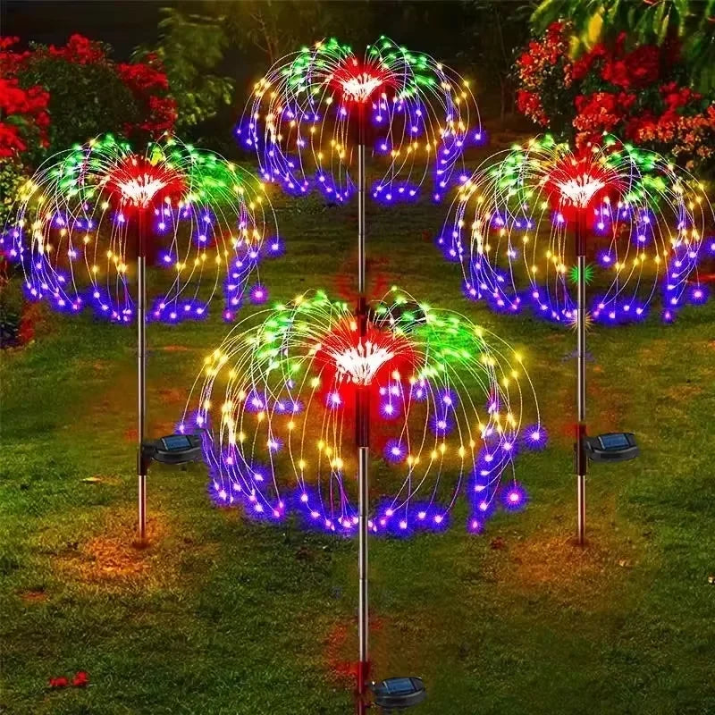 Colorful outdoor string lights on metal stands in a garden setting