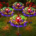 Colorful outdoor string lights on metal stands in a garden setting