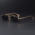 Gold-framed sunglasses with black lenses on a dark background