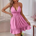 Woman wearing a pink dress in an indoor setting
